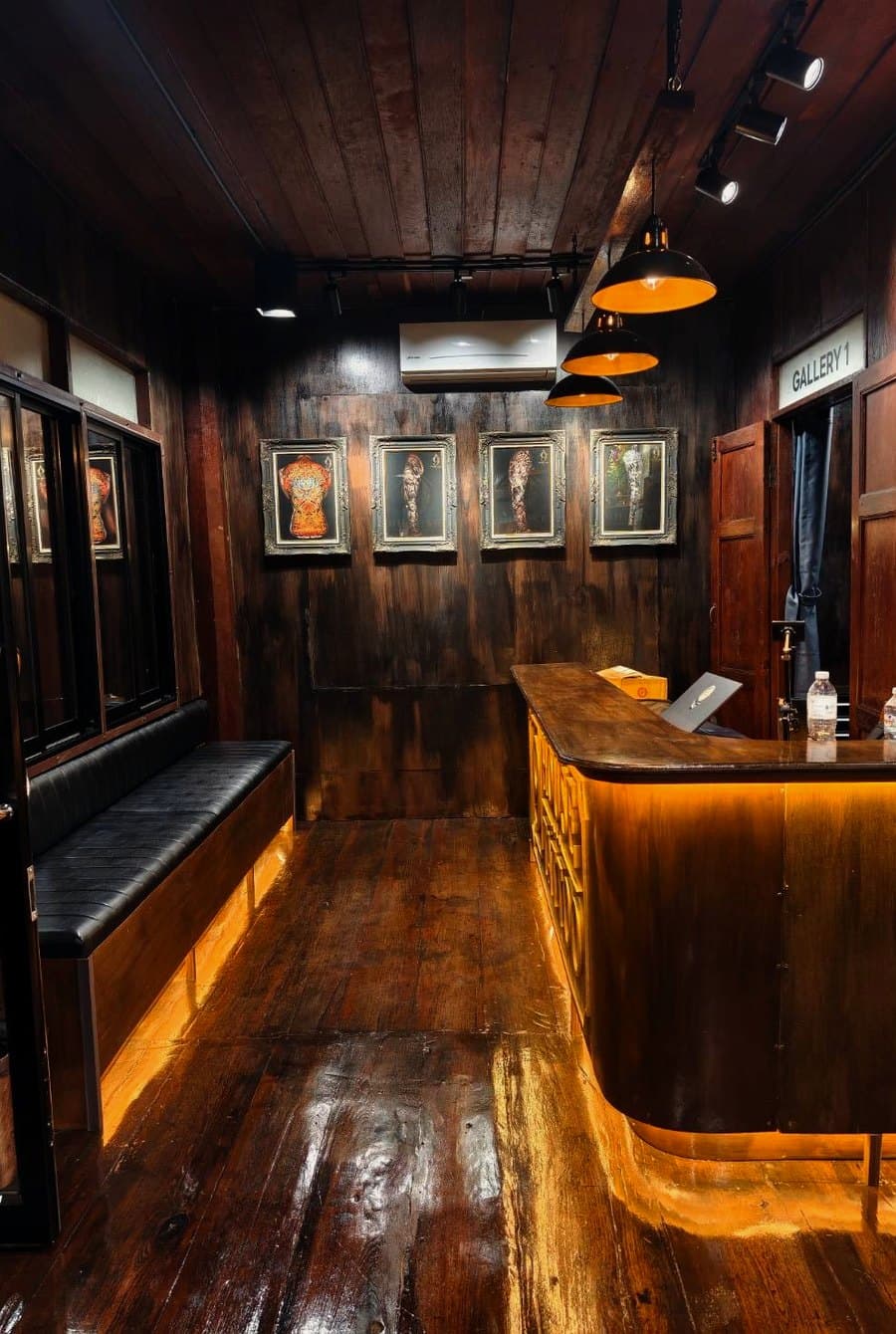The reception at 9 House Tattoo, the carved desk sign lit