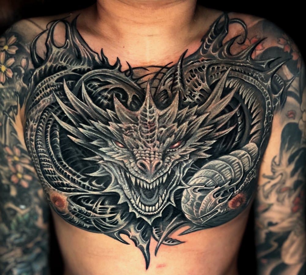 A large black and grey dragon chest piece, tattooed at 9 House